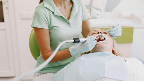 Dental hygienist performing a deep cleaning procedure at Finer Smiles Dental in Encino CA